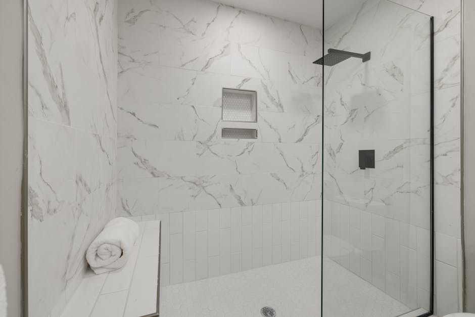Modern walk-in shower with sleek glass enclosure and premium fixtures